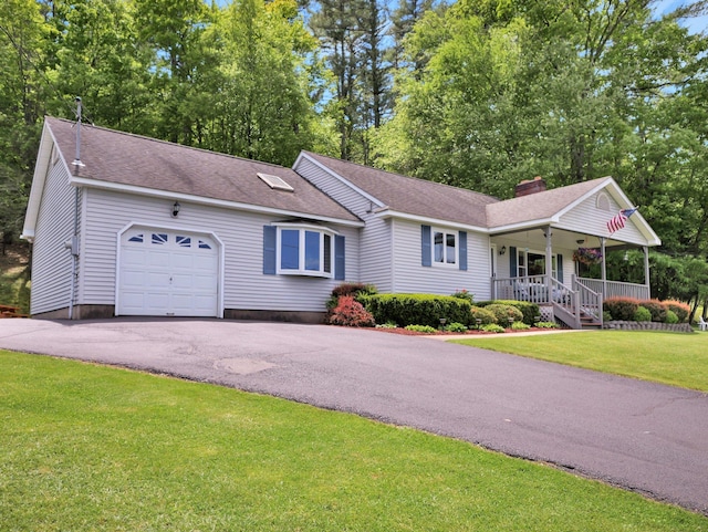229 Eldred Yulan Rd, Eldred, NY 12792 - view of front of property featuring an attached garage, covered porch, a chimney, driveway, and a front yard