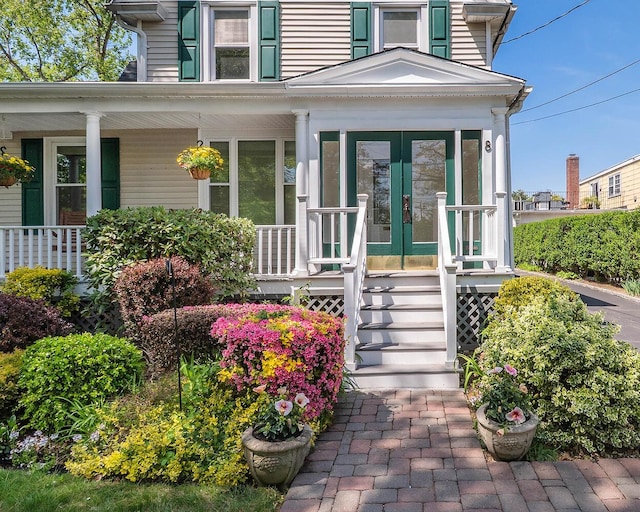 doorway to property with covered porch and french doors