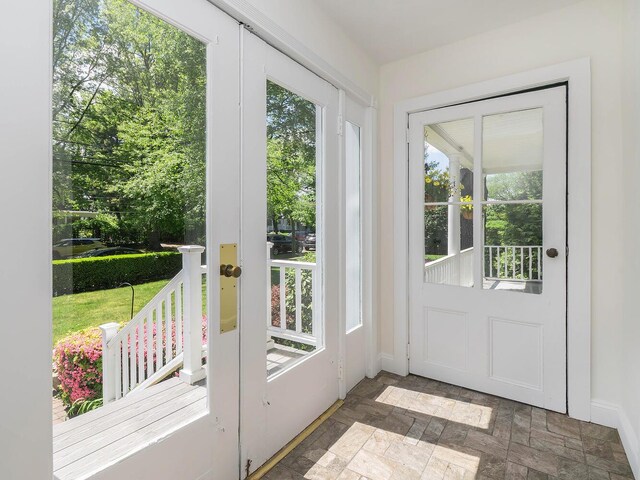entryway with baseboards and stone finish flooring