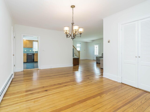unfurnished dining area featuring baseboard heating, stairs, a chandelier, light wood-style flooring, and baseboards