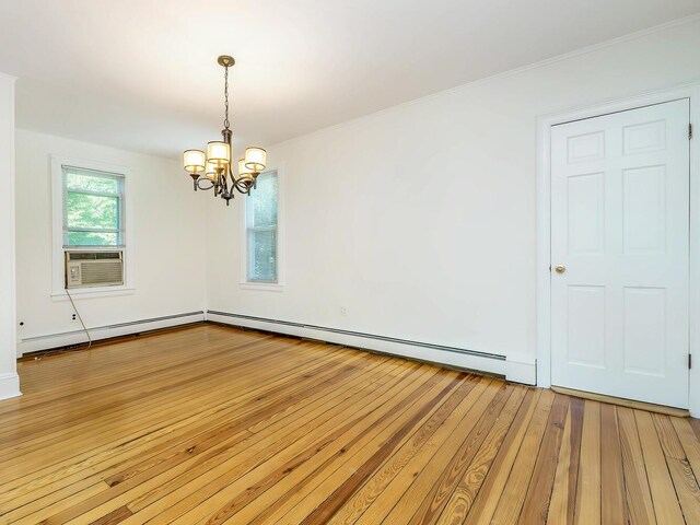 spare room featuring a chandelier, light wood-style flooring, cooling unit, baseboard heating, and ornamental molding
