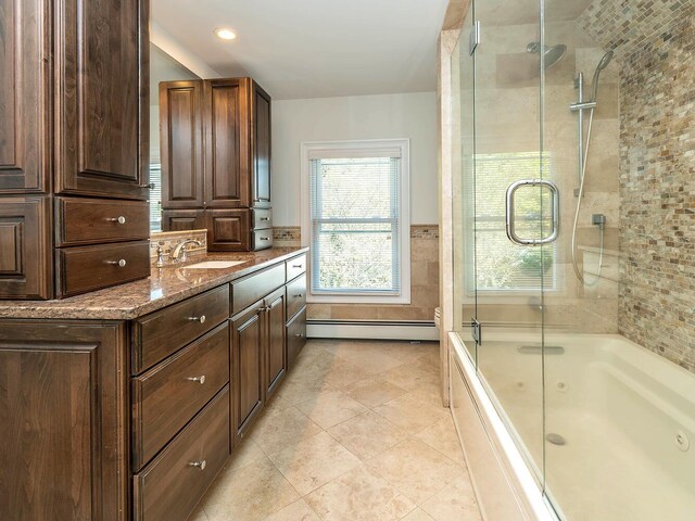 full bathroom featuring a baseboard heating unit, shower / bath combination with glass door, vanity, tile patterned flooring, and recessed lighting