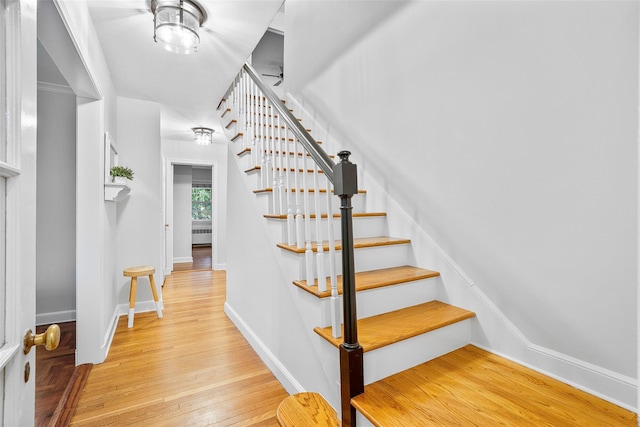 208 Wagner Ave, Mamaroneck, NY 10543 - stairway with wood-type flooring and baseboards