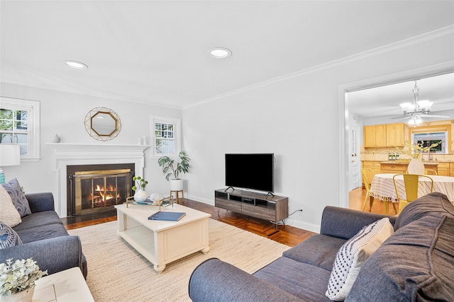 208 Wagner Ave, Mamaroneck, NY 10543 - living area with a glass covered fireplace, plenty of natural light, baseboards, recessed lighting, and ornamental molding