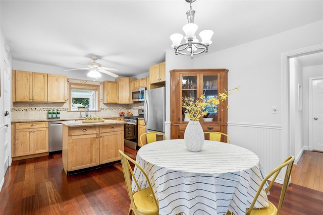 208 Wagner Ave, Mamaroneck, NY 10543 - kitchen featuring stainless steel appliances, dark wood finished floors, backsplash, a chandelier, and a kitchen island