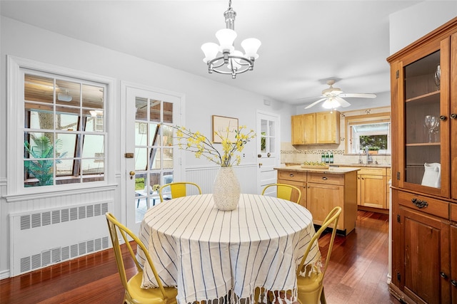 208 Wagner Ave, Mamaroneck, NY 10543 - dining area with radiator, a chandelier, dark wood-style flooring, and ceiling fan