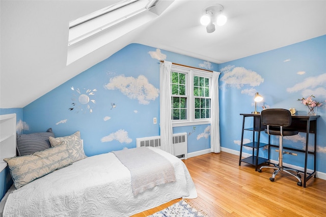 208 Wagner Ave, Mamaroneck, NY 10543 - bedroom featuring radiator heating unit, wood finished floors, a skylight, vaulted ceiling, and baseboards