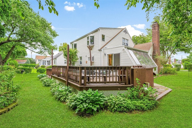 208 Wagner Ave, Mamaroneck, NY 10543 - rear view of house featuring a chimney, a yard, and a wooden deck