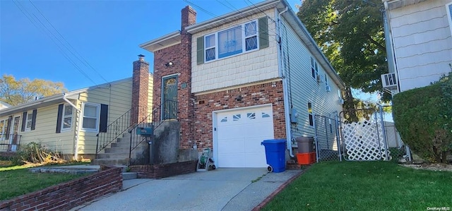 view of front of home featuring a chimney, a garage, brick siding, and a front yard