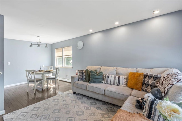 175 Frederick Ave, South Floral Park, NY 11001 - living room featuring wood finished floors, baseboards, a baseboard heating unit, recessed lighting, and a chandelier