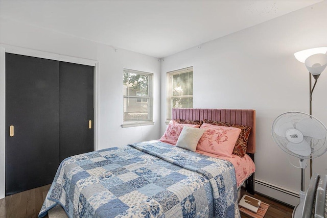 175 Frederick Ave, South Floral Park, NY 11001 - bedroom featuring baseboard heating, wood finished floors, and a closet