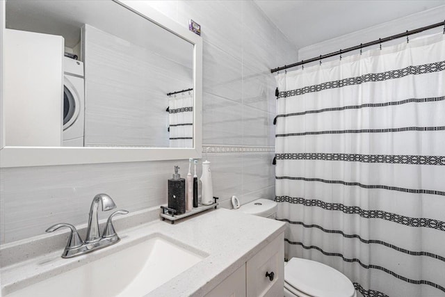 175 Frederick Ave, South Floral Park, NY 11001 - bathroom with tile walls, washer / dryer, toilet, backsplash, and curtained shower