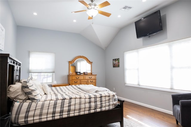 bedroom with wood finished floors, recessed lighting, baseboards, a ceiling fan, and lofted ceiling