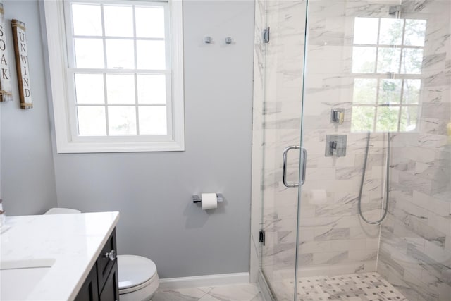 full bathroom featuring healthy amount of natural light, vanity, a stall shower, and toilet
