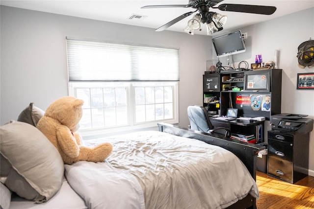 bedroom with wood finished floors and a ceiling fan