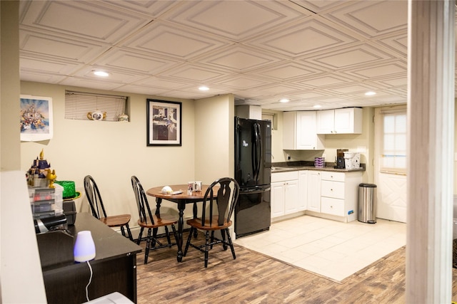 kitchen featuring freestanding refrigerator, dark countertops, white cabinetry, an ornate ceiling, and recessed lighting