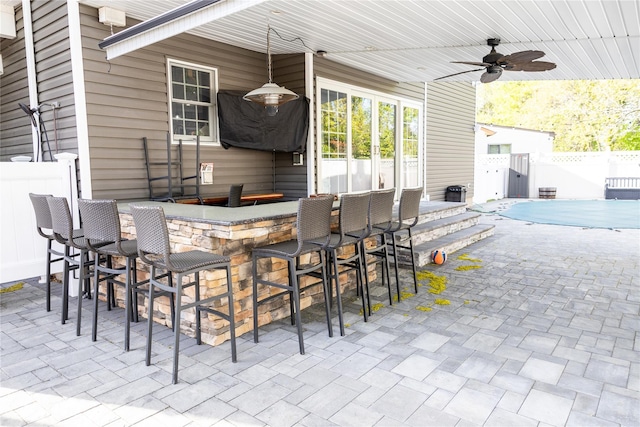 view of patio / terrace featuring fence and a ceiling fan