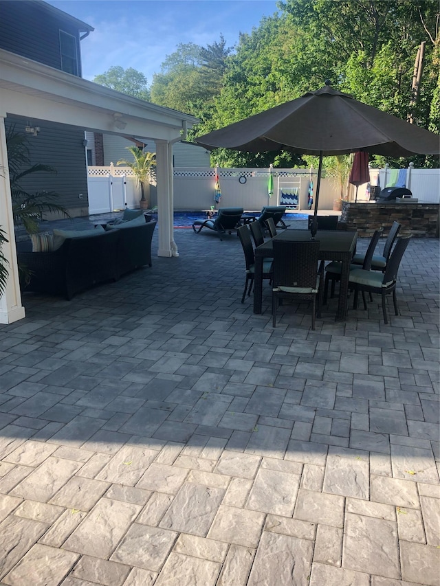 view of patio / terrace featuring a fenced backyard, outdoor dining area, and exterior kitchen