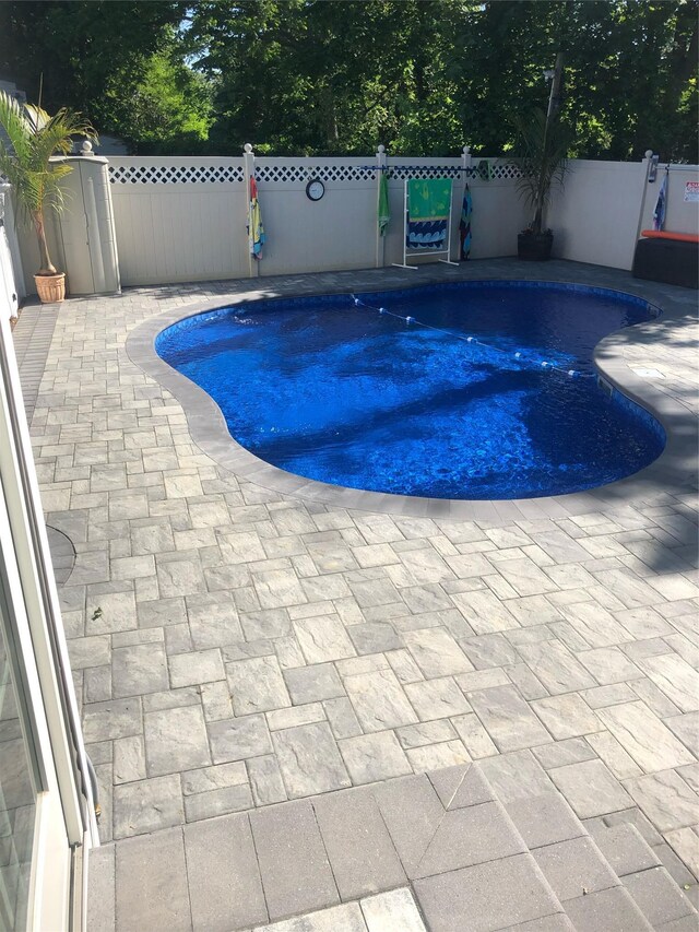 view of pool with fence and a patio