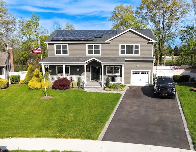52 S Windhorst Ave, Bethpage, NY 11714 - view of front of home with a porch, a garage, roof mounted solar panels, roof with shingles, and driveway