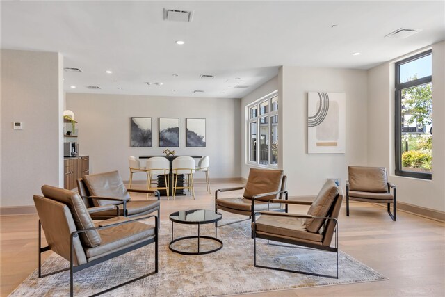 living area with wood finished floors, baseboards, and recessed lighting