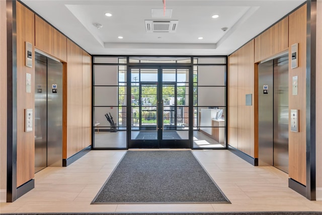 community lobby featuring wood walls and recessed lighting