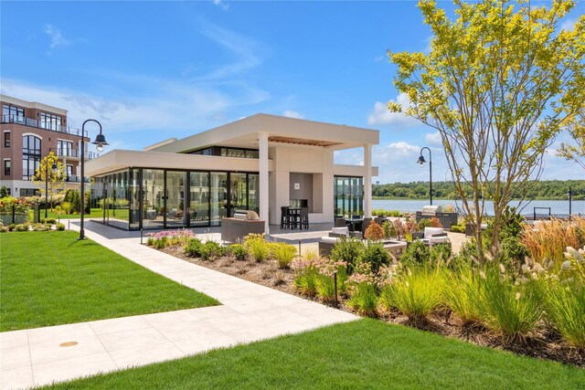 view of community with a lawn and a water view