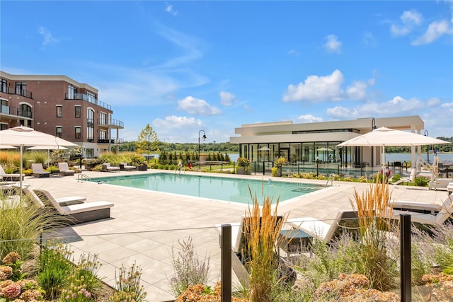 community pool featuring a patio area and fence