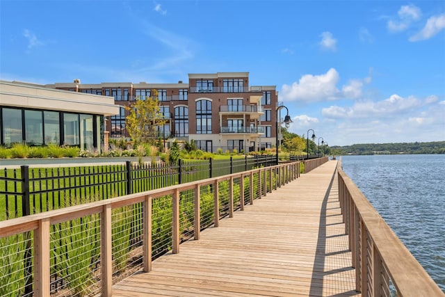 dock with a water view and fence