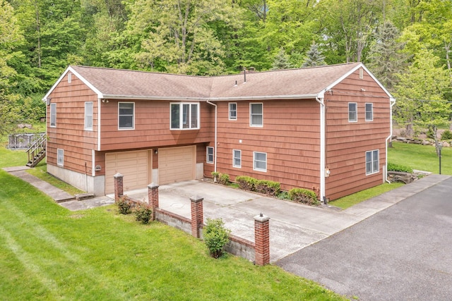 122 Minor Rd, Brewster, NY 10509 - view of front of home with concrete driveway, a garage, a shingled roof, stairs, and a front lawn