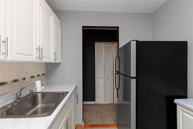 58-03 Calloway St Unit 3Nn, Corona, NY 11368 - kitchen with freestanding refrigerator, a sink, backsplash, and white cabinets
