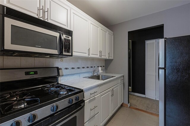 58-03 Calloway St Unit 3Nn, Corona, NY 11368 - kitchen with stainless steel appliances, light countertops, a sink, white cabinetry, and backsplash