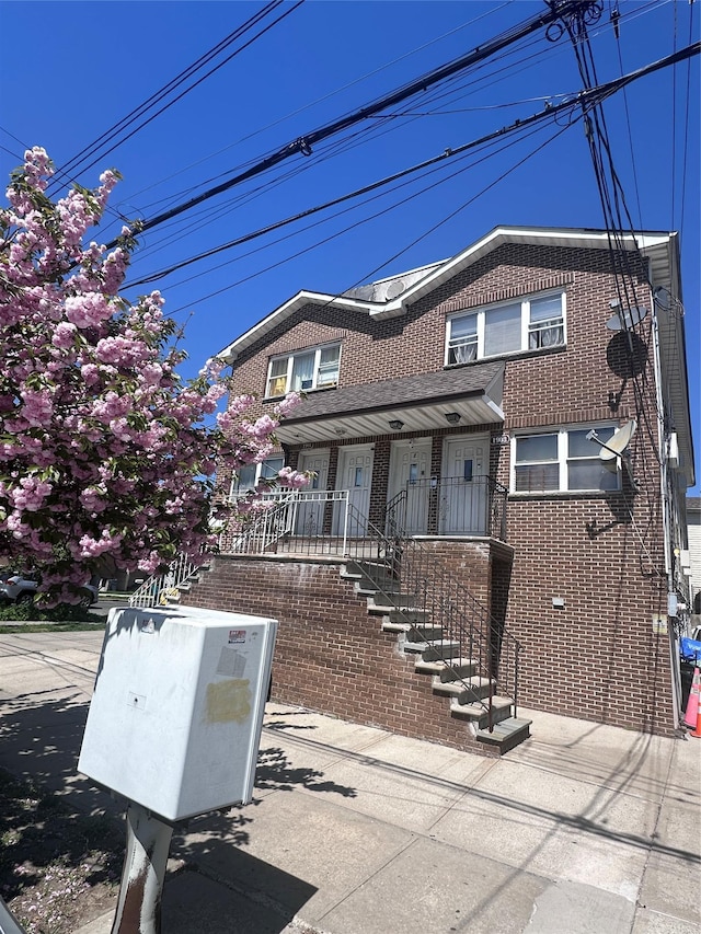 1903 Arnow Ave, Bronx, NY 10469 - view of property featuring brick siding and covered porch