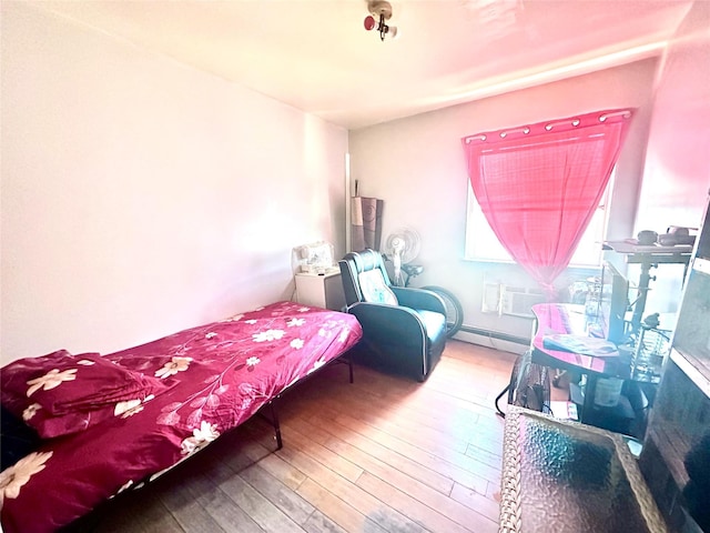1903 Arnow Ave, Bronx, NY 10469 - bedroom featuring baseboard heating and hardwood / wood-style floors