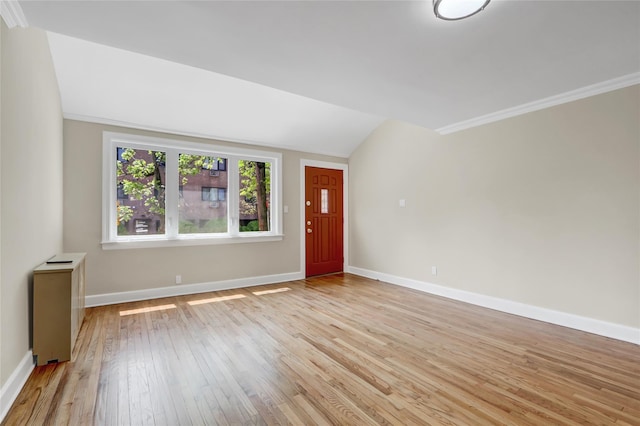 62-33 59th Dr, Maspeth, NY 11378 - unfurnished living room with light wood finished floors, baseboards, vaulted ceiling, and ornamental molding