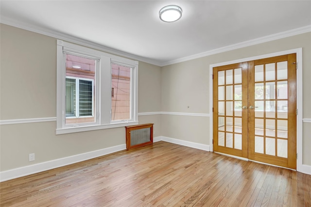 62-33 59th Dr, Maspeth, NY 11378 - spare room with french doors, ornamental molding, light wood-style floors, and baseboards