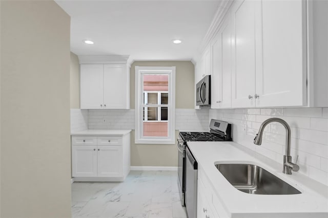 62-33 59th Dr, Maspeth, NY 11378 - kitchen featuring appliances with stainless steel finishes, a sink, recessed lighting, white cabinetry, and light countertops