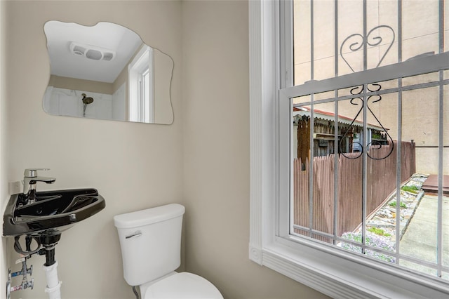 62-33 59th Dr, Maspeth, NY 11378 - bathroom featuring healthy amount of natural light, toilet, and a sink