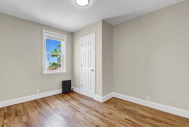 62-33 59th Dr, Maspeth, NY 11378 - empty room with radiator, baseboards, and wood finished floors