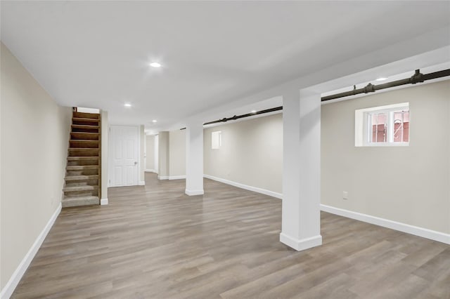 62-33 59th Dr, Maspeth, NY 11378 - basement featuring baseboards, stairs, wood finished floors, and recessed lighting