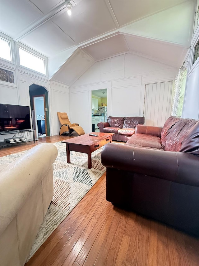37 New Ave, Yonkers, NY 10704 - living room with a decorative wall, light wood-style floors, vaulted ceiling, plenty of natural light, and arched walkways