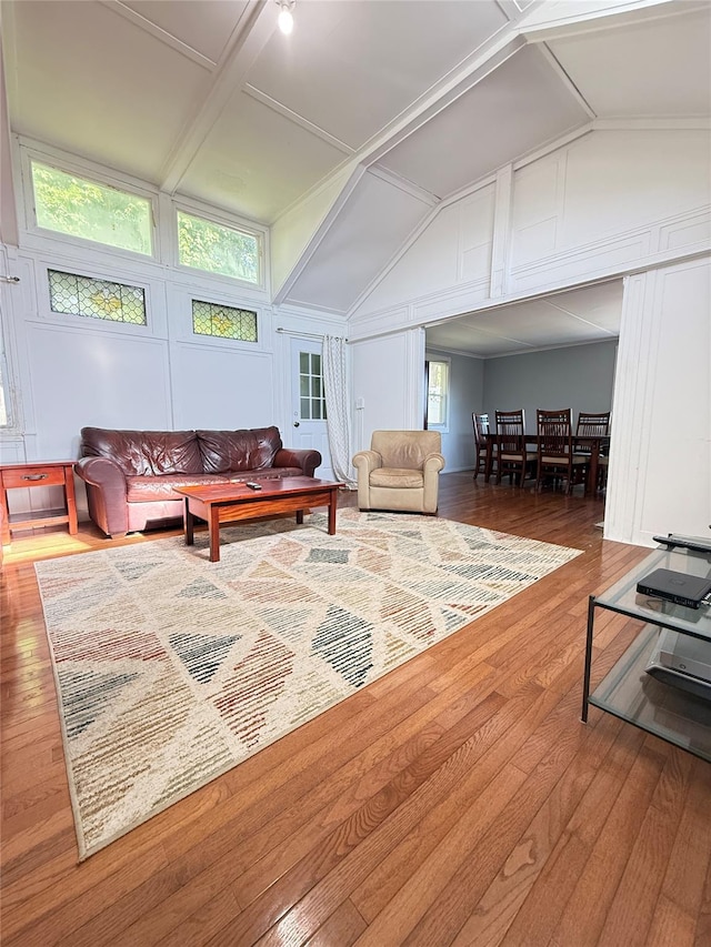 37 New Ave, Yonkers, NY 10704 - living area with plenty of natural light, vaulted ceiling, wood finished floors, and a decorative wall