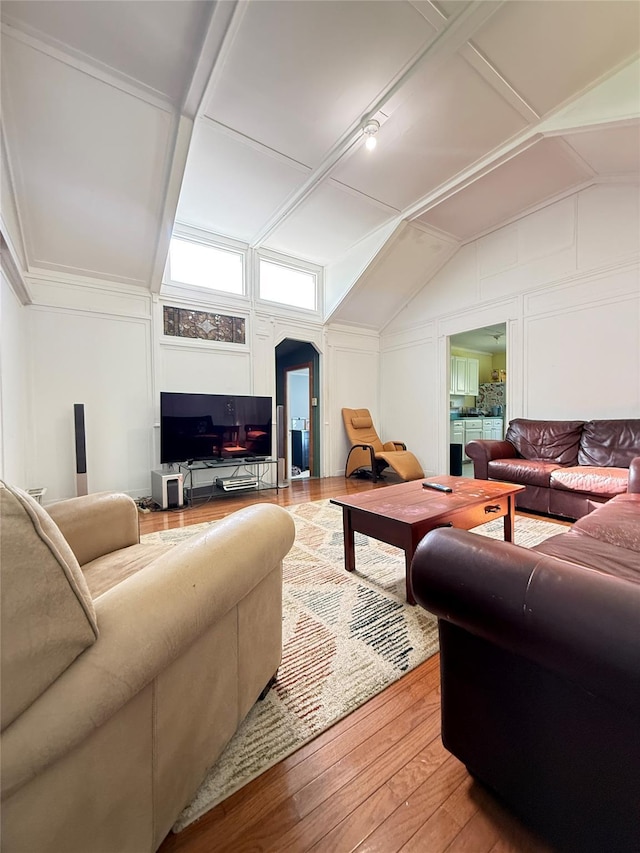 37 New Ave, Yonkers, NY 10704 - living area with arched walkways, wood-type flooring, vaulted ceiling, and a decorative wall