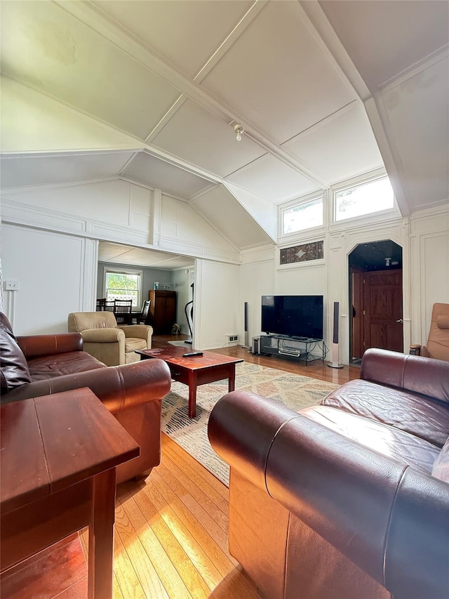 37 New Ave, Yonkers, NY 10704 - living room with light wood finished floors, vaulted ceiling, and a decorative wall