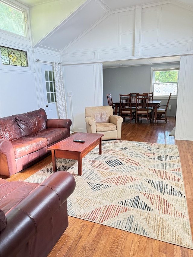 37 New Ave, Yonkers, NY 10704 - living room featuring wood-type flooring, lofted ceiling, and a decorative wall