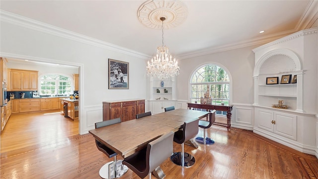406 Duck Pond, Locust Valley, NY 11560 - dining space with a decorative wall, ornamental molding, light wood-style floors, a chandelier, and wainscoting