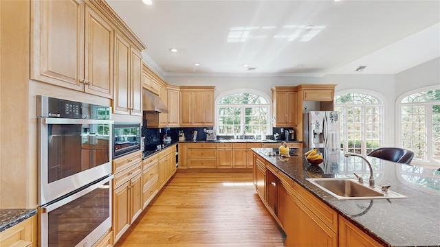 406 Duck Pond, Locust Valley, NY 11560 - kitchen with black appliances, a sink, under cabinet range hood, light wood-type flooring, and decorative backsplash
