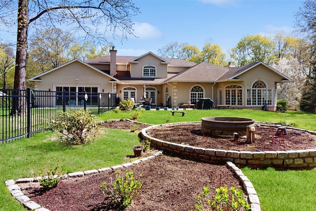 406 Duck Pond, Locust Valley, NY 11560 - back of property featuring an outdoor fire pit, stucco siding, and a shingled roof