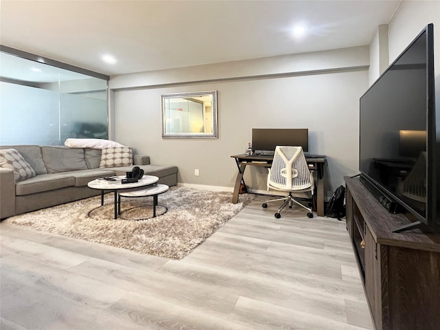 office area with light wood-type flooring, recessed lighting, and baseboards