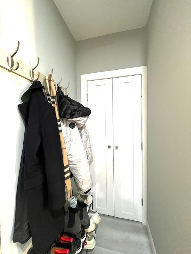 mudroom featuring wood finished floors and baseboards